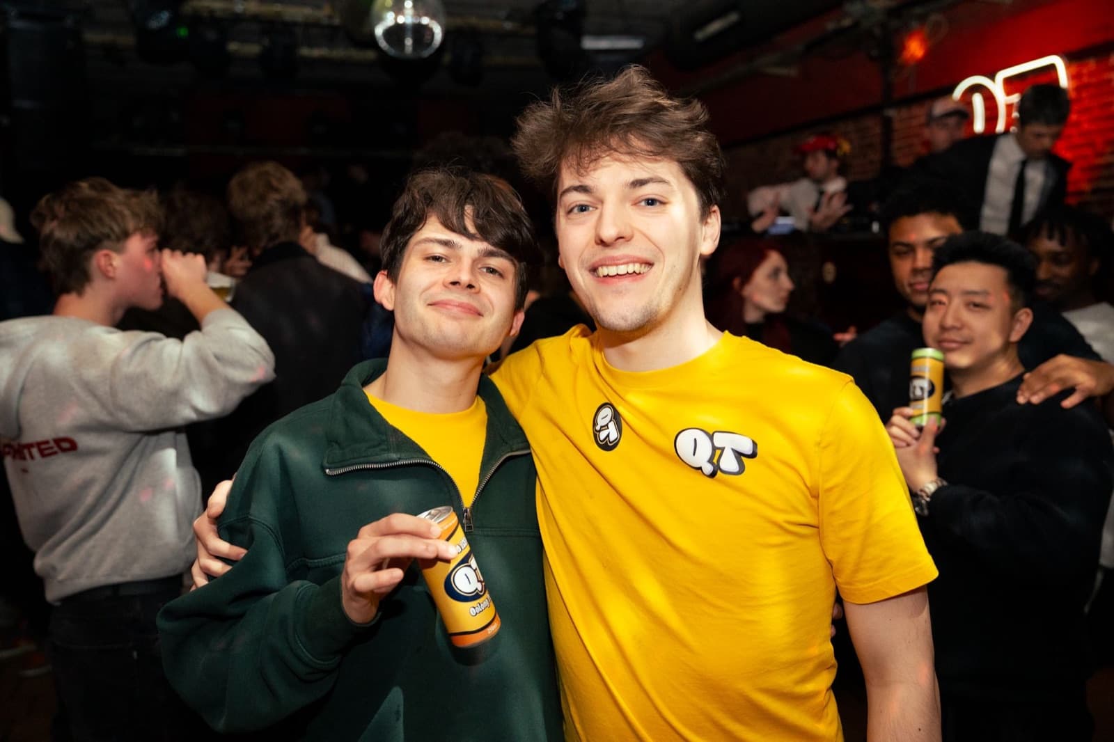 Bart and Laurent, the founders of QT Drink, holding a can of QT at a party